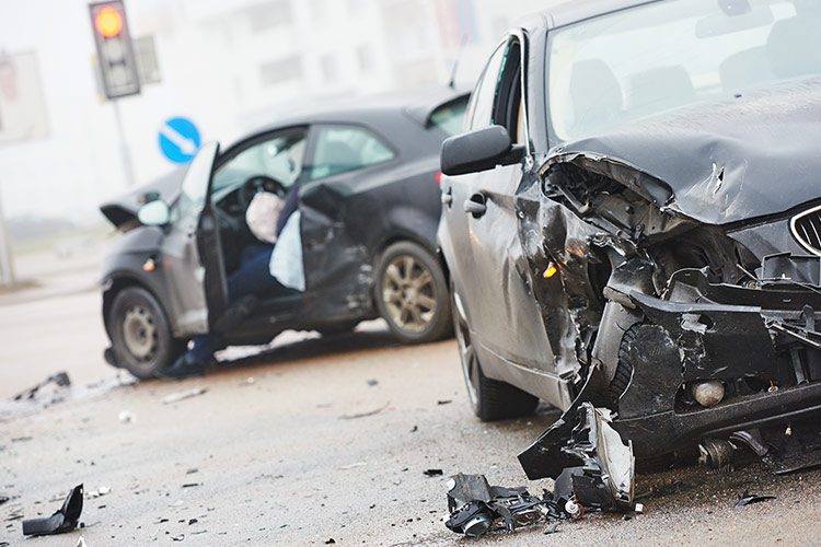 Two vehicles both seen very damaged after a terrible accident where airbags deployed.