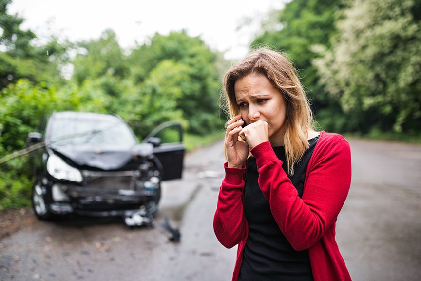 worried-woman-after-car-accident-calling-lawyer