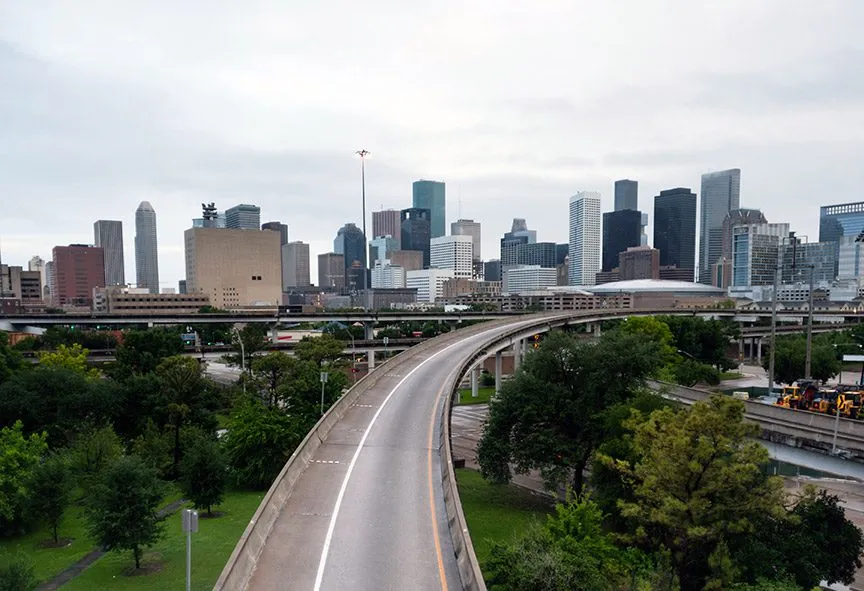 Skyline view of a downtown Houston highway overpass.