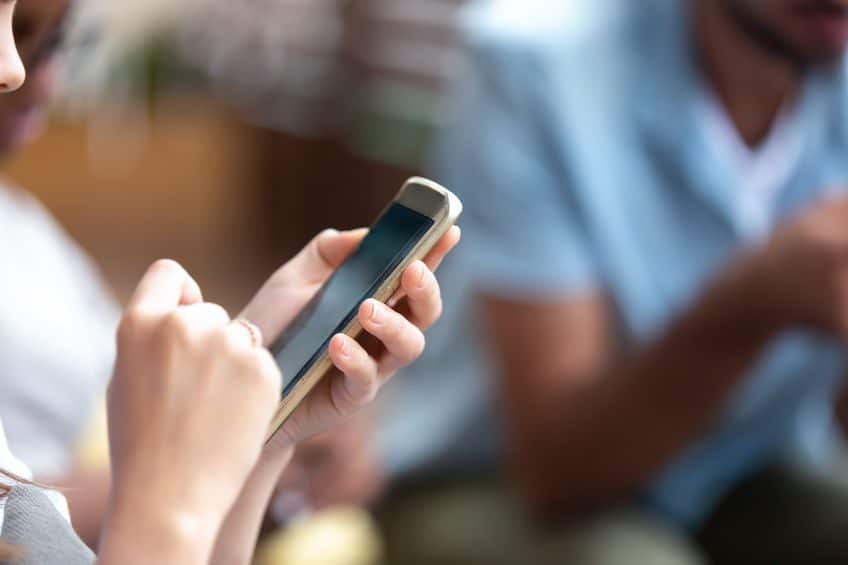 Person holding and interacting with a smartphone.
