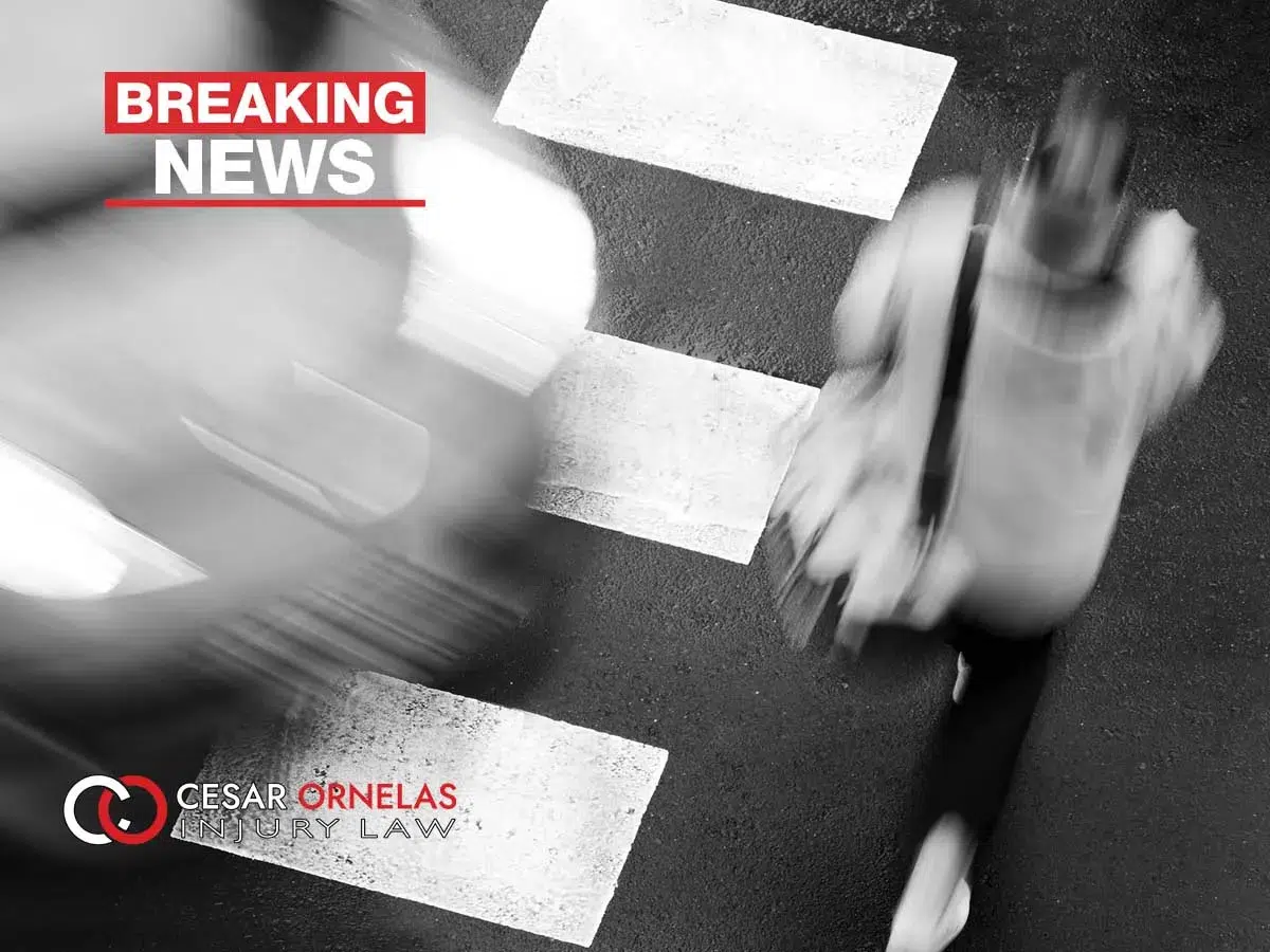 A pedestrian walking a crosswalk.