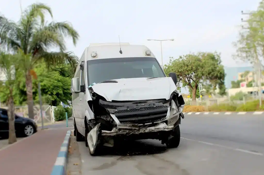 A commercial vehicle with severe front end damage.