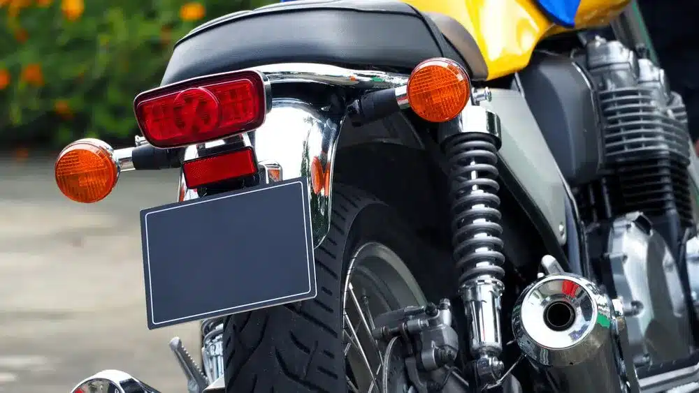 A yellow motorcycle parked with no license plate.