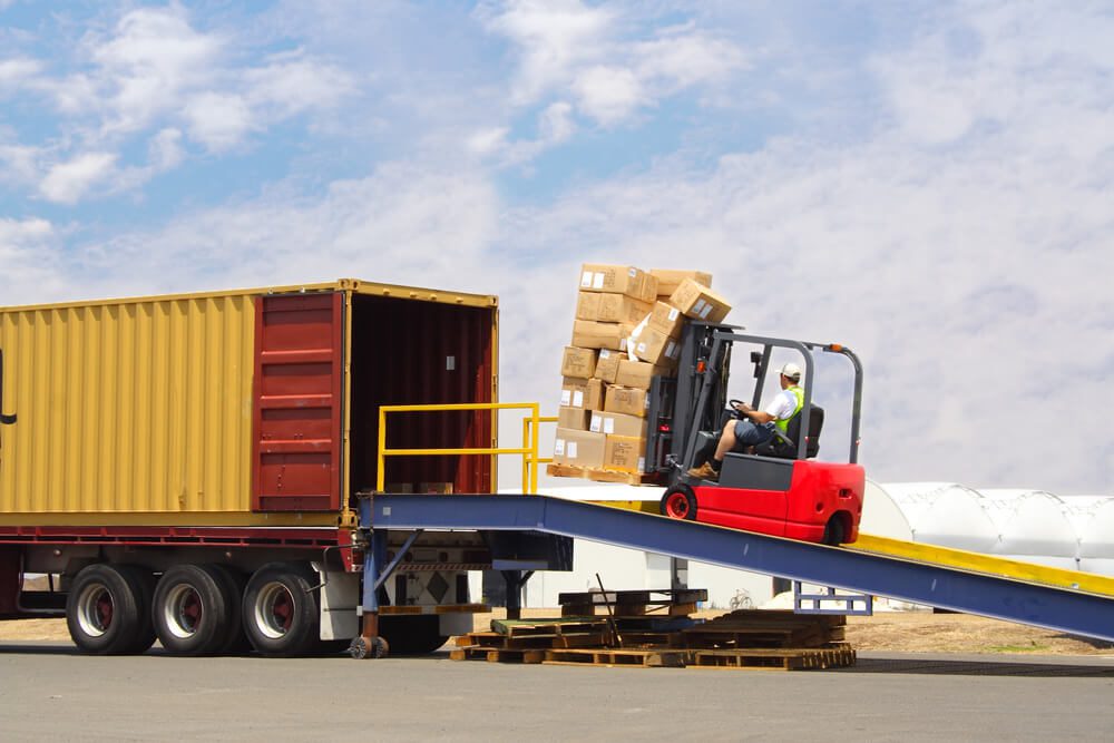 Forklift driver loading truck