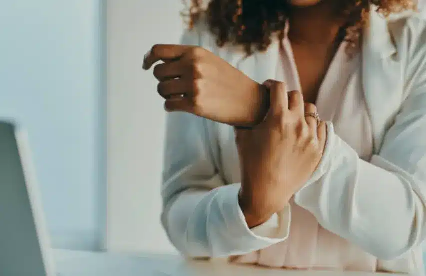 A person holding her wrist.