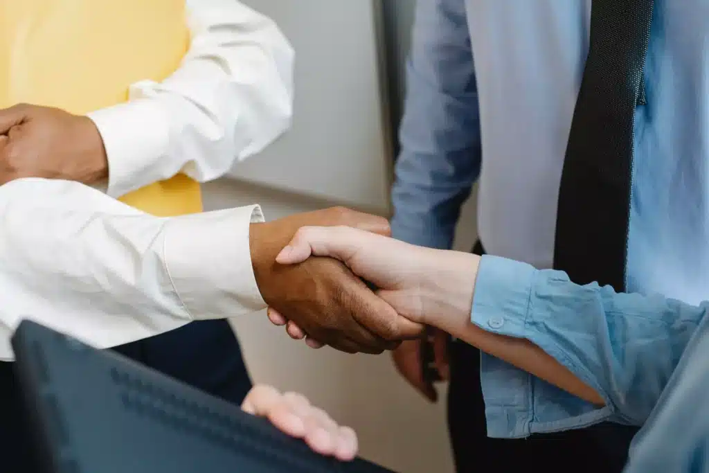 Clients shake hands with personal injury attorney.