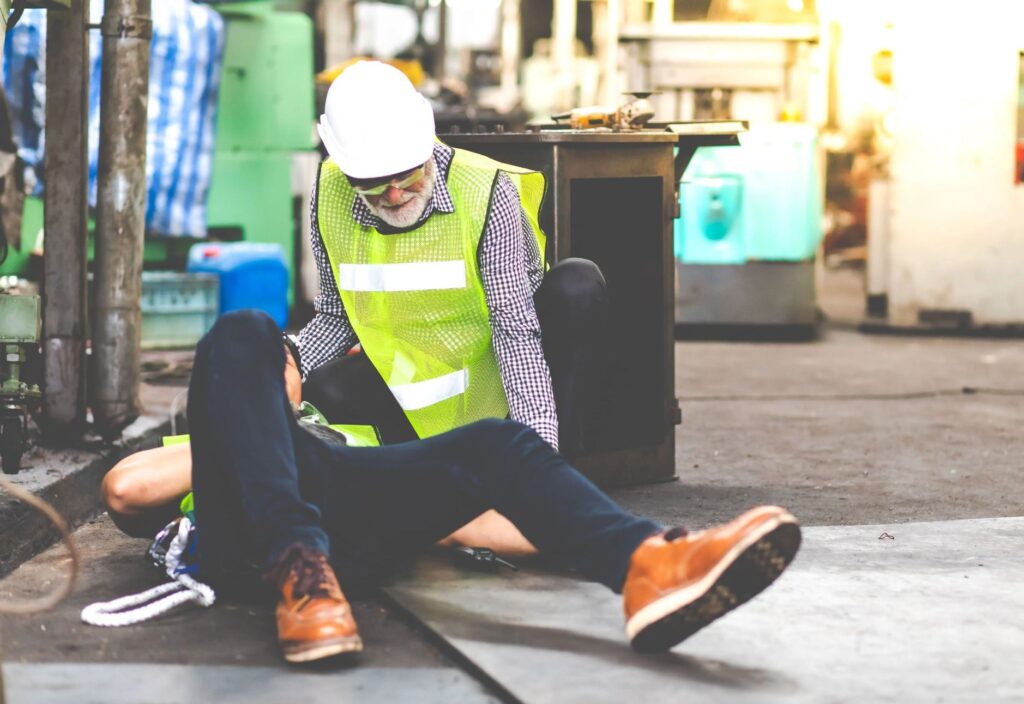 A construction worker hurt on the floor.