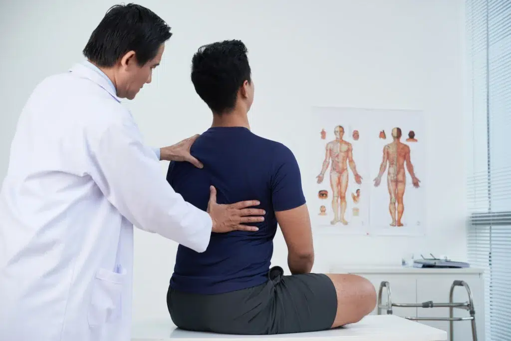 A patient getting their back examined.